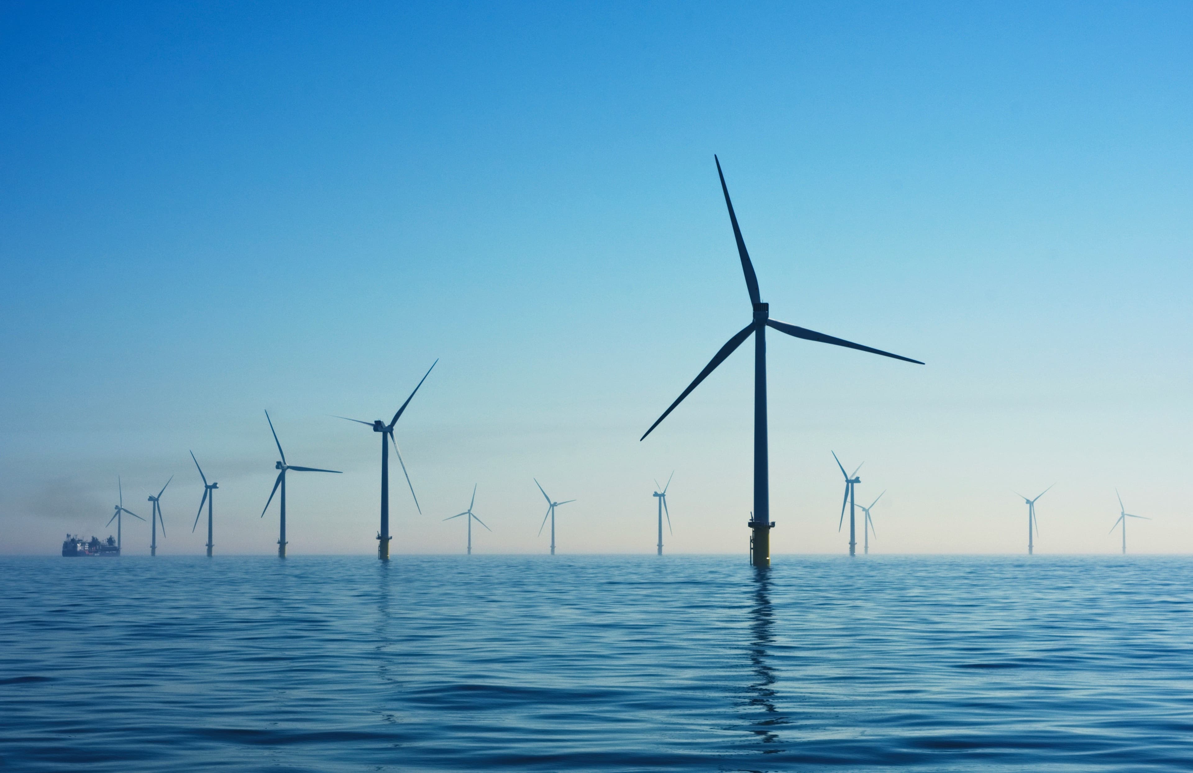 Offshore wind turbines in the sea, viewed across open water